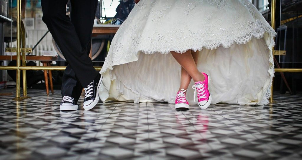 you see two people, maybe a wedding couple. One dress and the man in nice shoes.